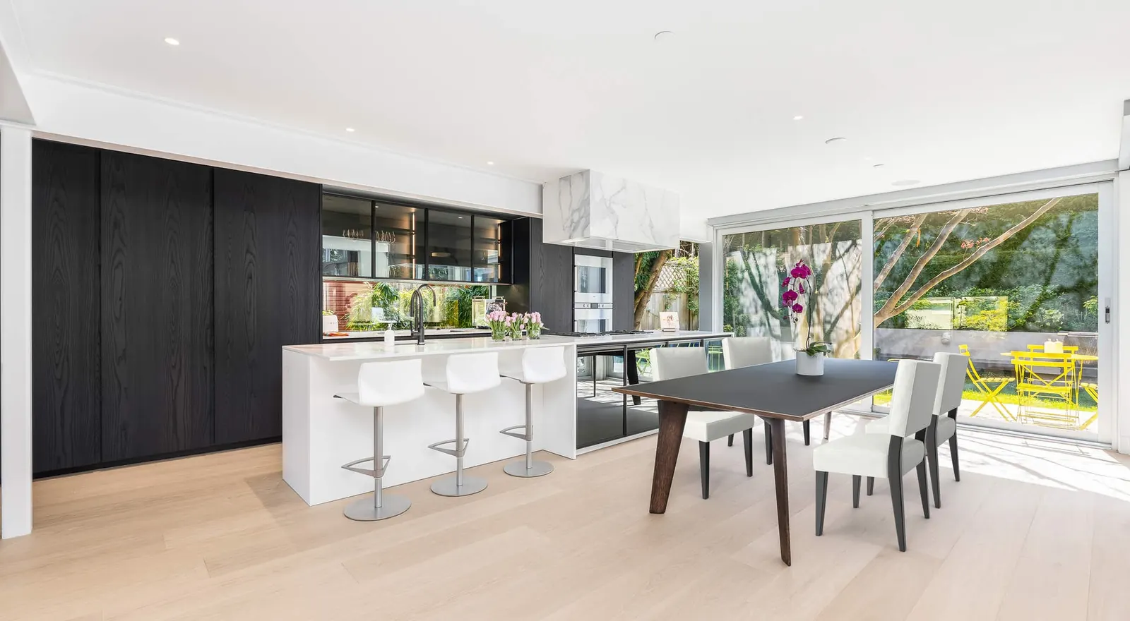 A galley kitchen on Vancouver's Westside with waterfall quartz counters, integrated appliances and custom cabinetry.