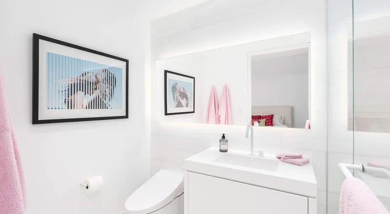 A bright family bathroom with a floating vanity, modern finishes and framed art.